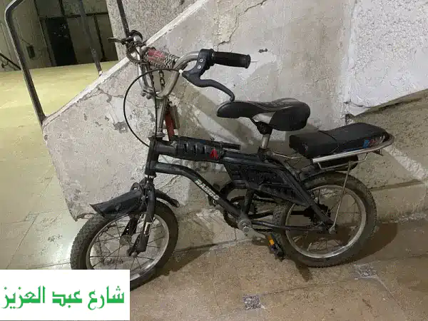 عجلة دراجة 14 بوصة بحالة ممتازة - كاوتش جديد!...